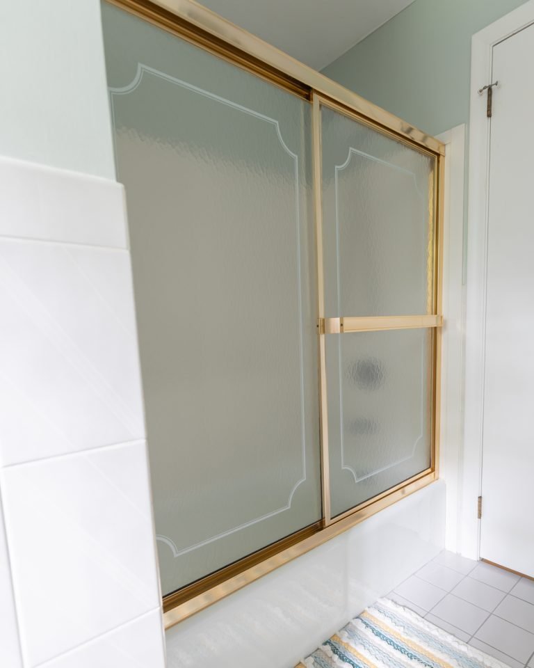 shower with gold metal frame and glass doors
